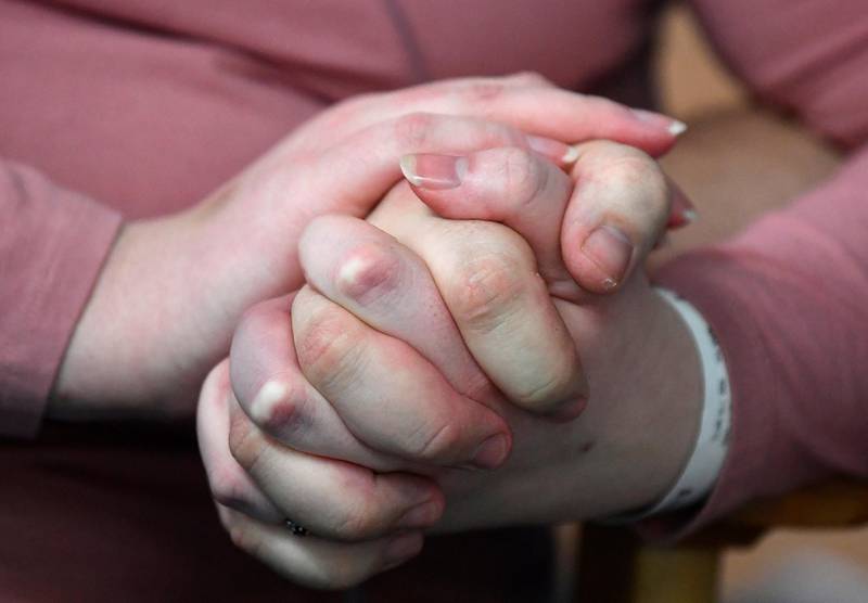 Elizabeth Kerr, 31, and Simon O'Brien, 36, hold hands in a COVID-19 ward, days after they married in an ICU (Intensive Care Unit) when both had become critically ill with the coronavirus disease (COVID-19), and were uncertain of their chances of surviving, in Milton Keynes University Hospital, Milton Keynes, Britain, January 20, 2021. Picture taken January 20, 2021. REUTERS/Toby Melville