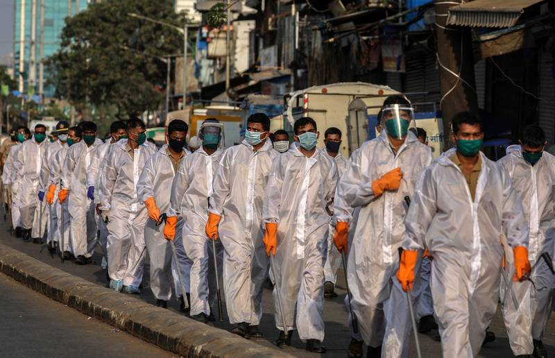 epa08369424 Indian police personnel wearing protective gear patrol in the streets of a hot spot area amid the nation-wide coronavirus lockdown in Mumbai, India, 17 April 2020. India's Prime Minister Narendra Modi on 14 April announced that the country's initial 21-day lockdown will be extended until 03 May 2020 in an attempt to curb the spread of of the SARS-CoV-2 coronavirus which causes the COVID-19 disease.  EPA/DIVYAKANT SOLANKI