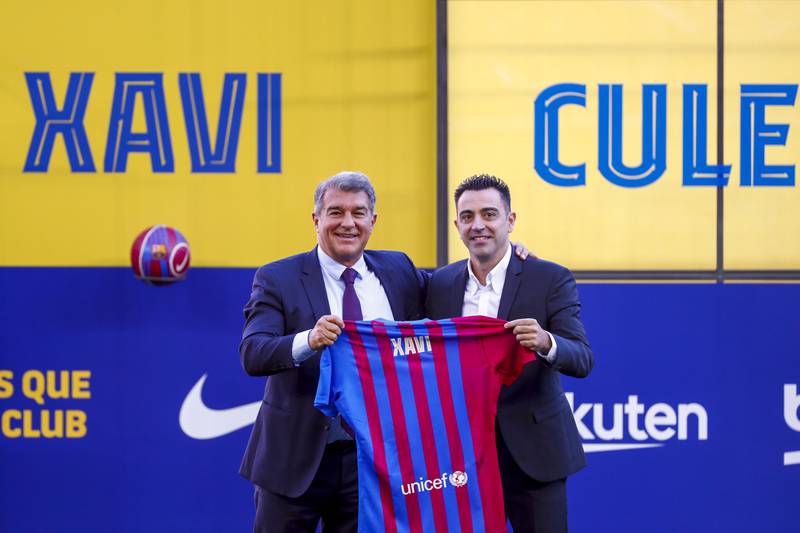 Xavi Hernandez and Joan Laporta hold up a Barcelona shirt during Xavi's official presentation at Camp Nou. AP
