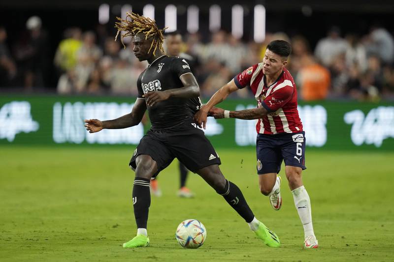 Chivas' Pavel Perez, right, pulls on the jersey of Juventus' Moise Kean during their friendly. AP