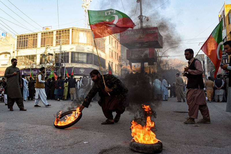 Activists of the Pakistan Tehreek-e-Insaf party burn tyres in Quetta, during a protest against the decision to disqualify former prime minister Imran Khan from holding office. AFP