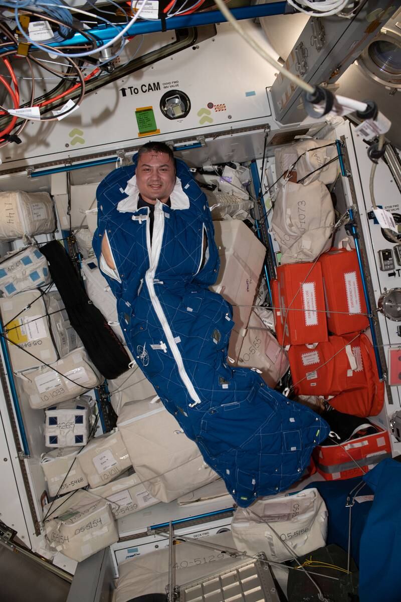 Nasa astronaut Kjell Lindgren poses for a portrait inside a crew sleeping bag on the ISS