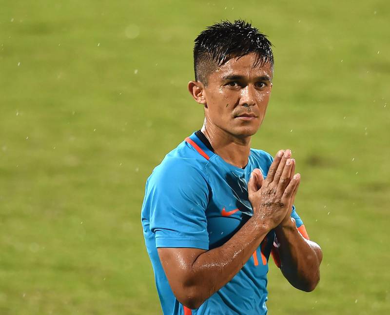 India's captain Sunil Chhetri (C) greets his team's supporters after winning the Hero Intercontinental Cup football match between India and Kenya, in Mumbai, on June 4, 2018. - India's football international against Kenya on Monday sold out in hours following captain Sunil Chhetri's emotional plea for fans to support the team after barely 2,500 people turned up to watch them play last week. (Photo by PUNIT PARANJPE / AFP)