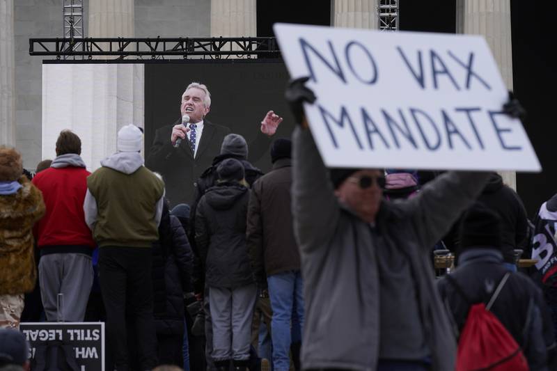Mr Kennedy is broadcast on a large screen as he addresses the January anti-vaccine rally.  AP