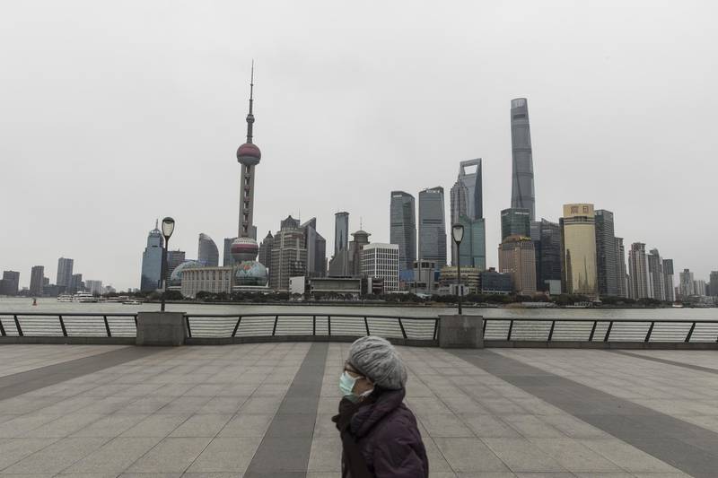 A pedestrian walks along the Bund waterfront in Shanghai, China. Bloomberg