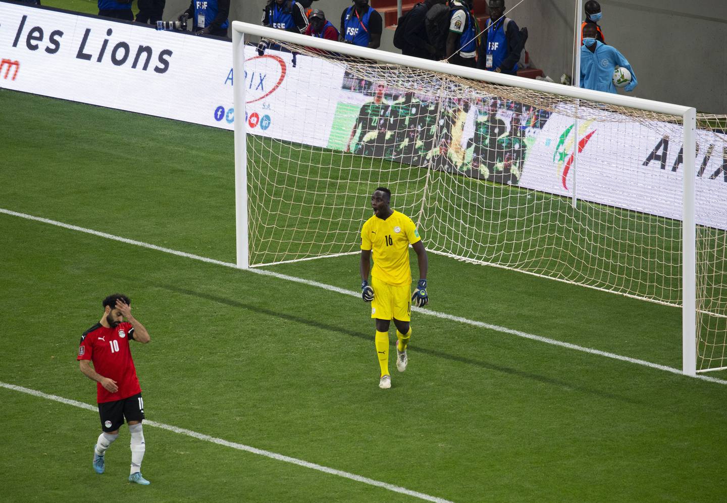 Mohamed Salah, left, reacts after failing to score his penalty kick against Senegal's goalkeeper Edouard Mendy. AP Photo