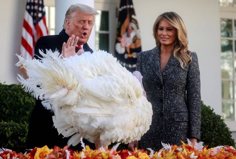 U.S. President Donald Trump stands with first lady Melania Trump as he pardons the National Thanksgiving Turkey "Corn" during the 73rd annual presentation in the Rose Garden at the White House in Washington, U.S., November 24, 2020. REUTERS/Hannah McKay     TPX IMAGES OF THE DAY