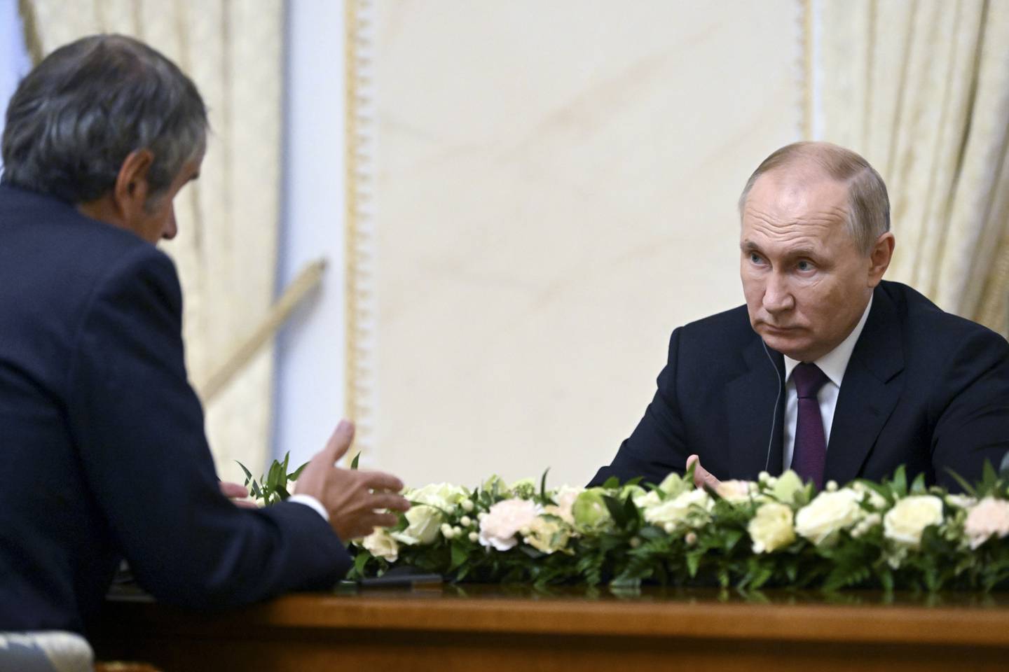 Russian President Vladimir Putin, right, listens to Rafael Mariano, director of the International Atomic Energy Agency in Saint Petersburg last Tuesday. AP Photo