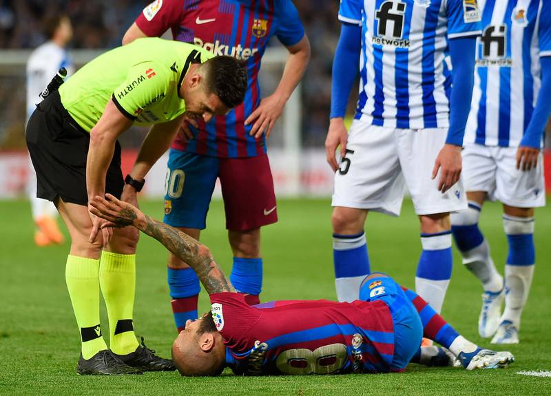 Spanish referee Del Cerro Grande checks on Barcelona's Brazilian defender Dani Alves. AFP