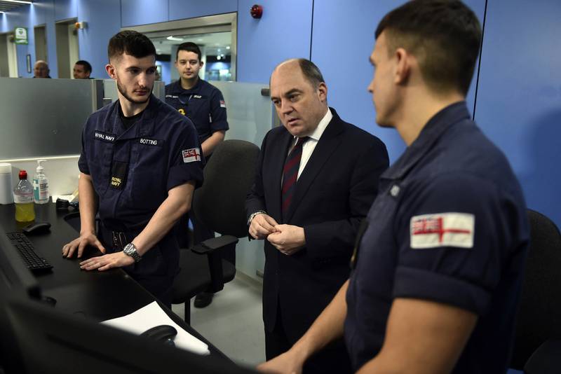 UK Defence Secretary Ben Wallace, centre, at Manchester airport in December meeting members of the military covering for striking Border Force officers. AP