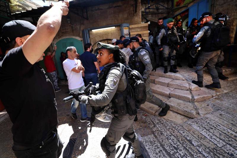 An Israeli border police member confronts Palestinian man during protests at Damascus Gate in East Jerusalem. AFP