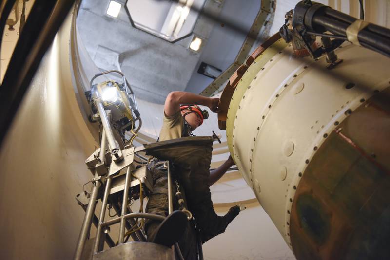 An airman at Malmstrom works on an intercontinental ballistic missile during a Simulated Electronic Launch-Minuteman test. AP