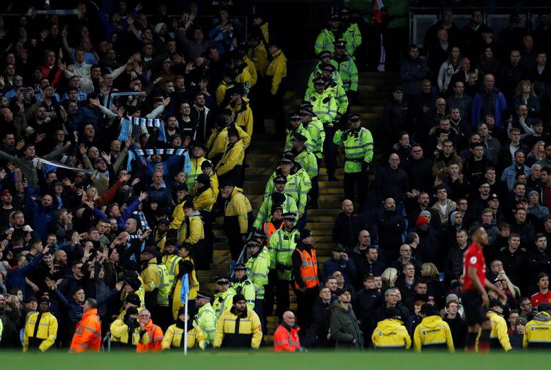 Police officers in the stands between Manchester City and Manchester United fans. Reuters