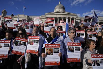 Israeli supports show placards with the faces and names of people taken believed to be taken hostage and held in Gaza, during a protest in Trafalgar Square. AP