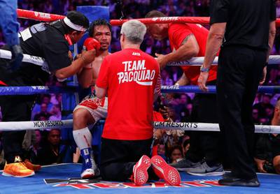 Freddie Roach gives his instructions to Manny Pacquiao between rounds. AP Photo