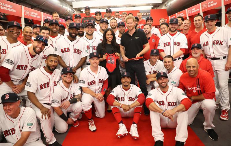 LONDON, ENGLAND - JUNE 29: In this handout image provided by The Invictus Games Foundation, Prince Harry, Duke of Sussex and Meghan, Duchess of Sussex join the Boston Red Sox in their Clubhouse and receive gifts for Archie ahead of their match against the New York Yankees at the London Stadium  in London, England. The historic two-game "You Just Cant Beat The Person Who Never Gives Up" series marks the sports first games ever played in Europe and The Invictus Games Foundation has been selected as the official charity of Mitel and MLB London Series 2019. Getty Images
