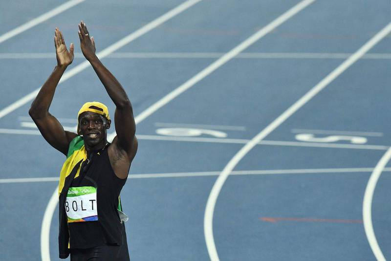 Jamaica’s Usain Bolt claps as he celebrates after he won the men’s 100m final during the Rio 2016 Olympics at the Olympic Stadium in Rio de Janeiro on August 14, 2016. Jewel Samad / AFP