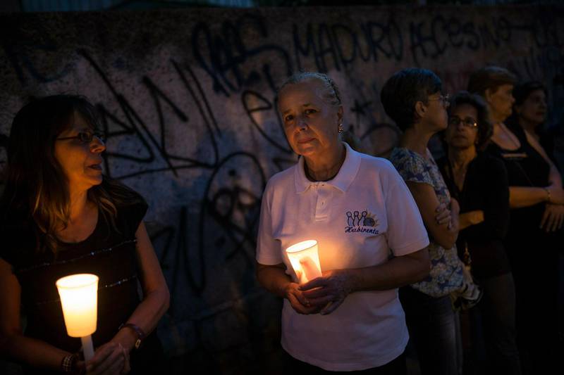 Anti-government protesters hold a candlelight vigil in Caracas for a person killed during protests against the Venezuelan President Nicolas Maduro. AP Photo