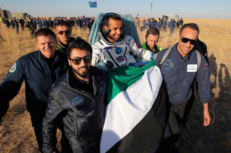 Russian space agency rescue team members and United Arab Emirates specialists carry Maj Al Mansouri. AP Photo
