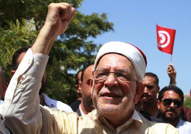 Abdelfattah Mourou, the Ennahda party's candidate in Tunisia's presidential election, waves to supporters after submitting his candidacy in Tunis on August 9, 2019. AFP