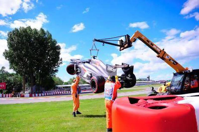 A mobile crane lifts Esteban Gutierrez's Sauber car at the Canadian Grand Prix in Montreal. Tragedy struck soon after when a marshal was killed after he slipped under the wheel of the crane, officials said. Emmanuel Dunand / AFP