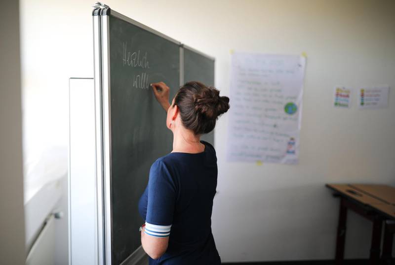 Teacher Birgit Steinbach prepares a classroom, for a reopening to execute the high school graduation exams, during the spread of the coronavirus disease (COVID-19), at the Protestant grammar school in Kleinmachnow, Germany, April 16, 2020. REUTERS/Hannibal Hanschke