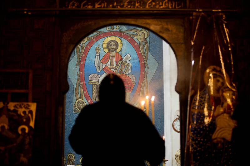 FILE - In this Jan. 6, 2018 file photo, a priest leads prayers prior to Christmas Eve Mass at the Virgin Mary church, in Cairo, Egypt. The killing of a respected bishop in a desert monastery north of Cairo has opened a rare window onto the cloistered world of Egyptâ€™s Coptic Orthodox Church. Itâ€™s one of the oldest Christian communities in the world and the one that introduced monasticism to the faith. But the killing of the abbot, and the arrest of two monks suspected in his death, has shaken the church. (AP Photo/Amr Nabil, File)