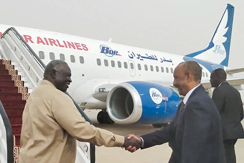 Gen Abdel Fattah Al Burhan, right, boarding a plane heading for Egypt at Port Sudan's airport. AFP