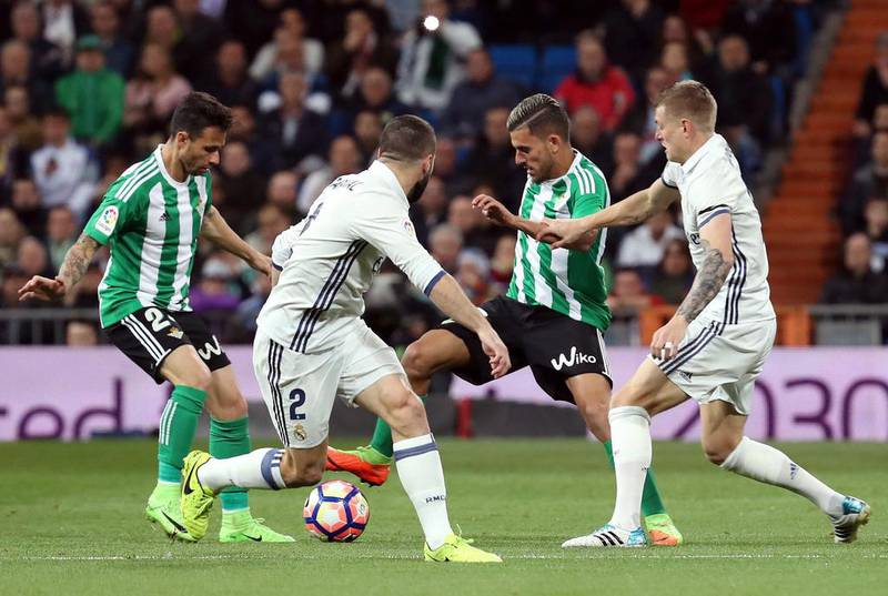 Dani Ceballos, second right, and Ruben Castro, left, of Betis vie for the ball with Real Madrid’s Toni Kroos, right, and Dani Carvajal. JJ Guillen / EPA