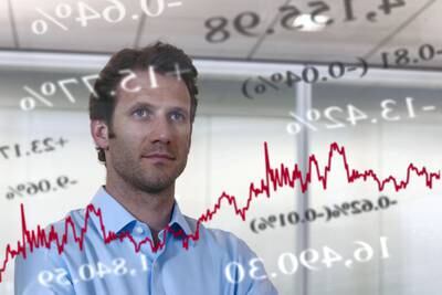 Businessman looking at financial market data. Getty Images