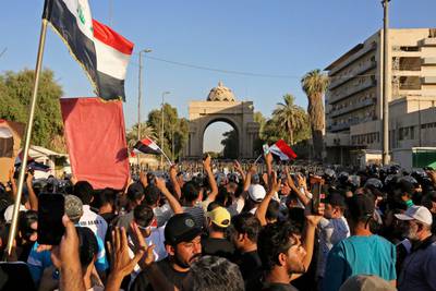 Mr Al Sadr's supporters gather outside the main gate of Baghdad's Green Zone. AFP