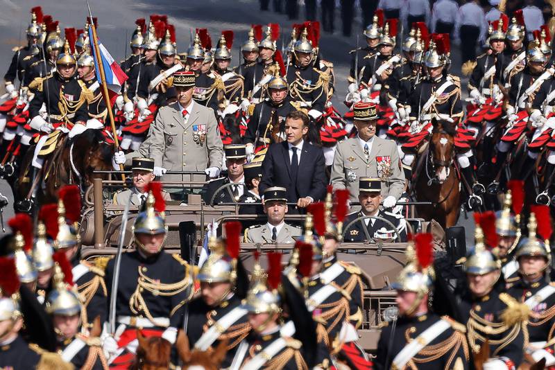 French President Emmanuel Macron rides in a vehicle during the Bastille Day military parade on the Champs-Elysees. AFP