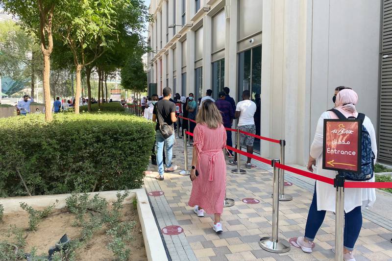 People line up outside Saudi Arabian fast food chain Al Baik which shares a building with the Afghanistan country pavilion. Reuters