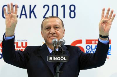 Turkey's President Recep Tayyip Erdogan gestures to supporters of his ruling Justice and Development Party (AKP), at a rally in Bingol, eastern Turkey, Saturday, Jan. 13, 2018. Erdogan has said Turkey will oust Kurdish militants from Afrin, northern Syria, as the military shelled the area from across the border. Turkey considers the YPG a terror group and an extension of the Kurdish insurgency within its own borders. (Pool Photo via AP)