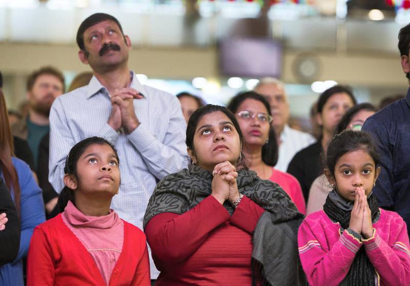 DUBAI, UNITED ARAB EMIRATES - Worshippers listening to the mass  by  Pope  Francis on the screen at St. Mary's Church, Oud Mehta.  Leslie Pableo for The National for Ramolas story