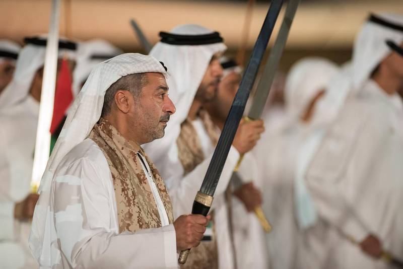 Sheikh Nahyan bin Hamdan bin Mohammed Al Nahyan, centre, dances during National Day celebrations at Adnec. Mohamed Al Suwaidi  / Crown Prince Court - Abu Dhabi