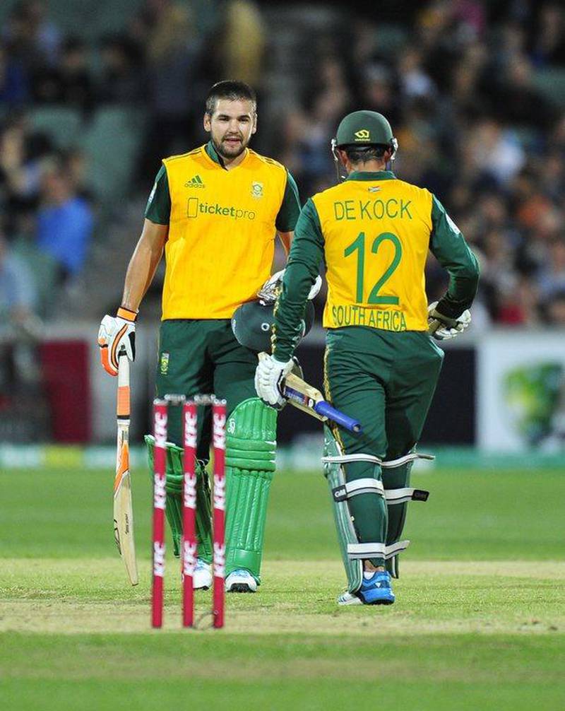 South Africans Quinton de Kock, near, and Rilee Rossouw, far, reach 100 for their partnership against Australia in a T20 international victory on Wednesday in Adelaide. David Mariuz / AFP / November 5, 2014