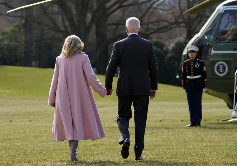 US President Joe Biden and first lady Jill Biden hold hands as they walk to board Marine One. Reuters