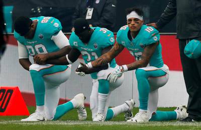 NFL Football - Miami Dolphins vs New Orleans Saints - NFL International Series - Wembley Stadium, London, Britain - October 1, 2017   Miami Dolphins players kneel during the U.S. national anthem before the match   Action Images via Reuters/Paul Childs