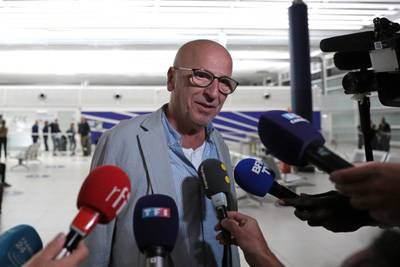A man evacuated from Niger speaks to journalists at Paris Charles de Gaulle airport. AFP
