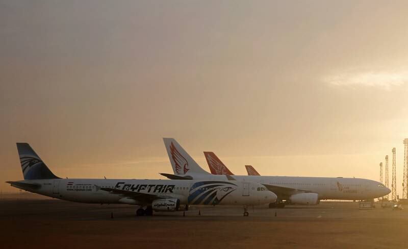 An EgyptAir plane is parked next to other planes on the runway of the Cairo International Airport, pictured through the window of an Etihad Airways plane in Egypt December 16, 2017. Picture taken December 16, 2017. REUTERS/Amr Abdallah Dalsh