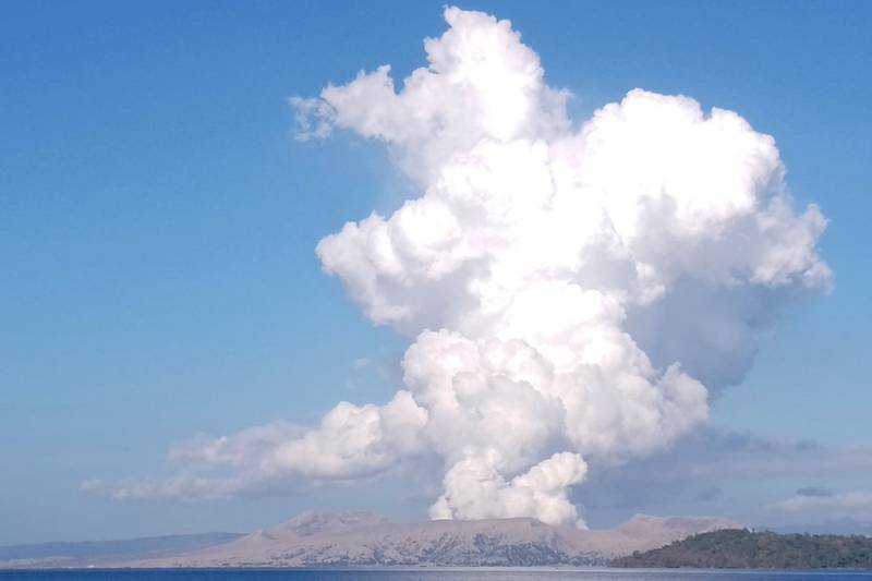 Taal, a small volcano in a scenic lake near the Philippine capital, belches a white plume of steam and ash 1.5 kilometres into the sky in a brief eruption on Saturday. AP