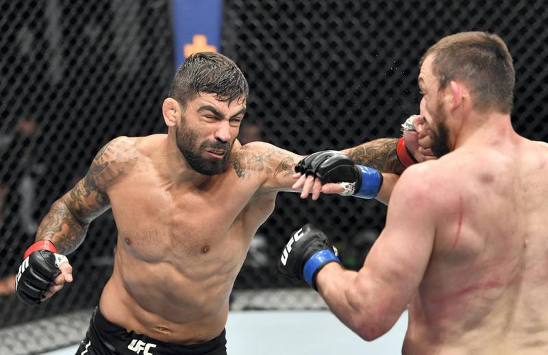 ABU DHABI, UNITED ARAB EMIRATES - JULY 12: (L-R) Elizeu Zaleski dos Santos of Brazil punches Muslim Salikhov of Russia in their welterweight fight during the UFC 251 event at Flash Forum on UFC Fight Island on July 12, 2020 on Yas Island, Abu Dhabi, United Arab Emirates. (Photo by Jeff Bottari/Zuffa LLC)