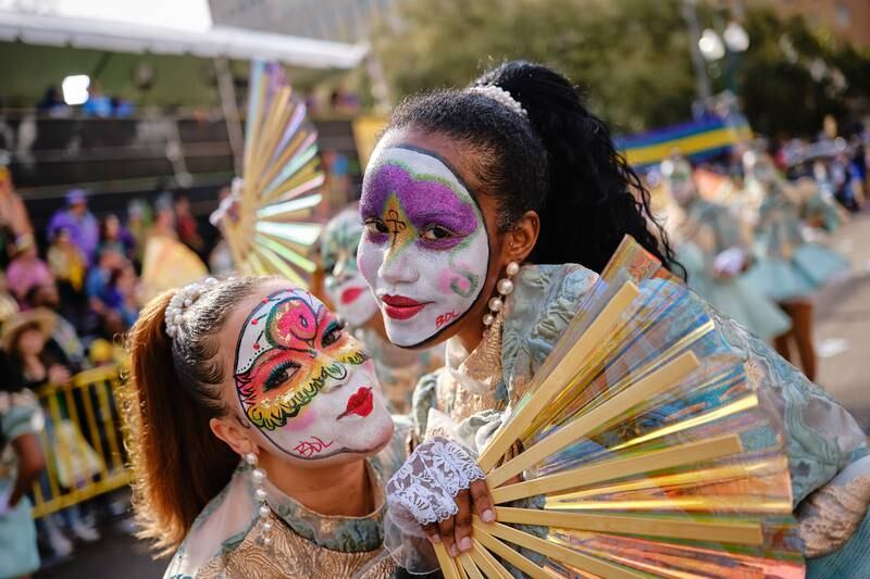 Members of a dance group pose while marching before the Krewe of Zulu. EPA