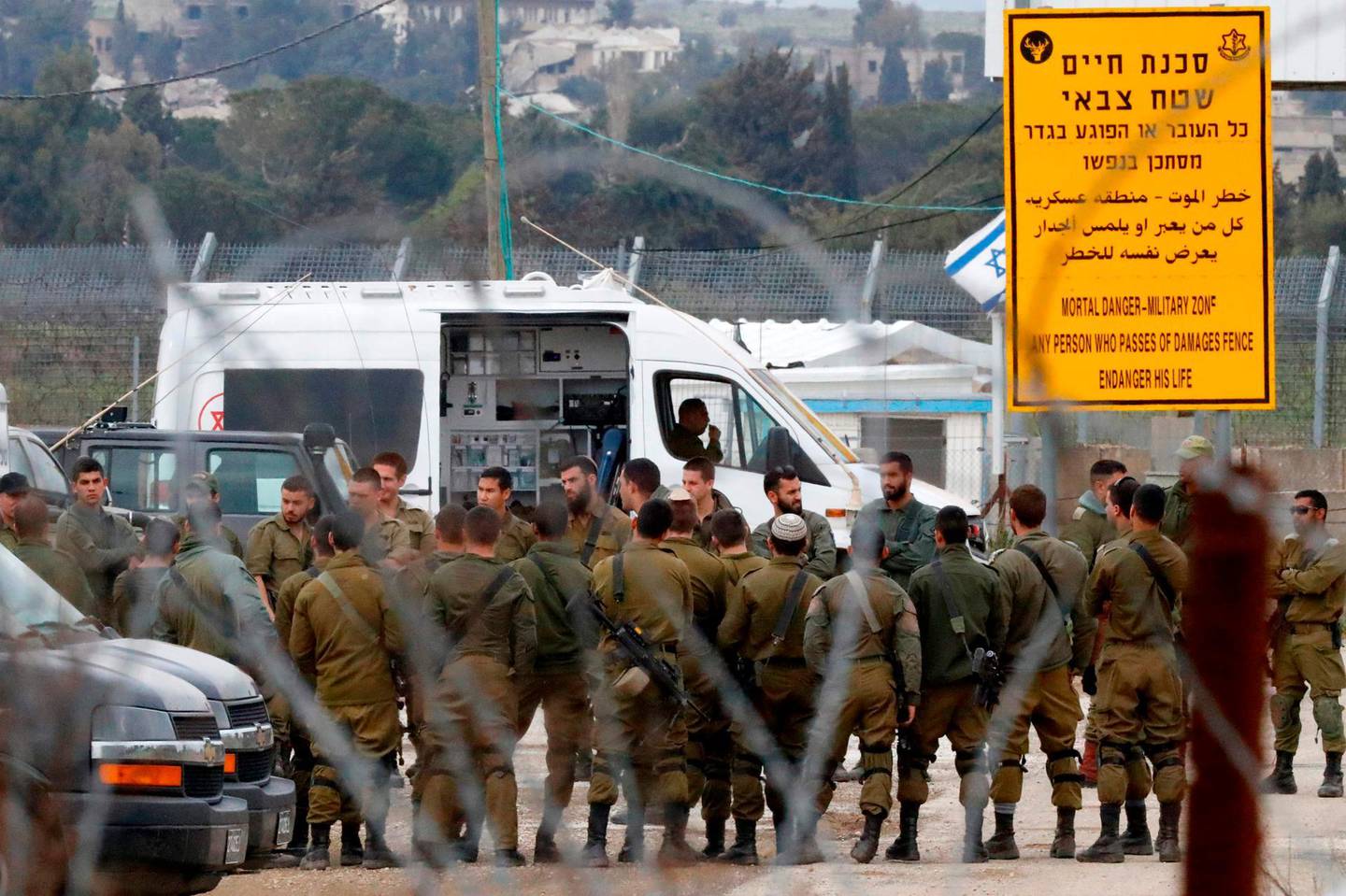 Israeli soldiers prepare at the Quneitra border crossing of the Israeli annexed-Golan Heights, on March 23, 2019, as demonstrations are expected on the Syrian side of the border to protest against the backing of Israel's capture of the Golan Heights by the US president. US President Donald Trump is again breaking diplomatic norms in backing Israel's capture of the Golan Heights. Israel conquered the Golan from Syria in the Six-Day War of 1967 and annexed it in 1981, but until now, the international community has not accepted the move, hoping the territory could serve as a bargaining chip in a future peace deal between the countries. But Trump on March 21 turned to Twitter for the abrupt diplomatic turnaround, saying that after 52 years, "it is time for the United States to fully recognize" Israeli sovereignty. / AFP / Jack GUEZ 
