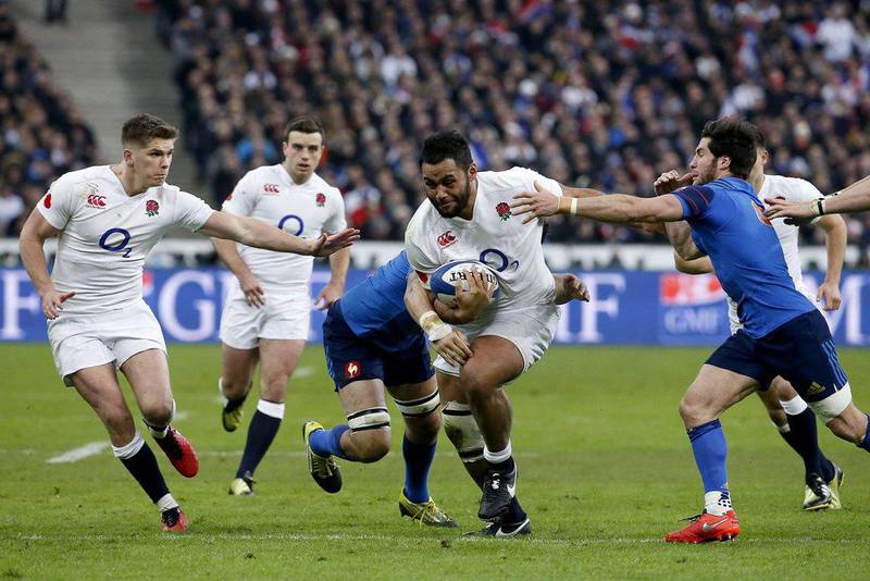 England's number 8 Billy Vunipola (C) runs to evade France's scrum-half Maxime Machenaud (R) during the Six Nations international rugby union match between France and England at the Stade de France in Saint-Denis, north of Paris, on March 19, 2016. AFP PHOTO / THOMAS SAMSON