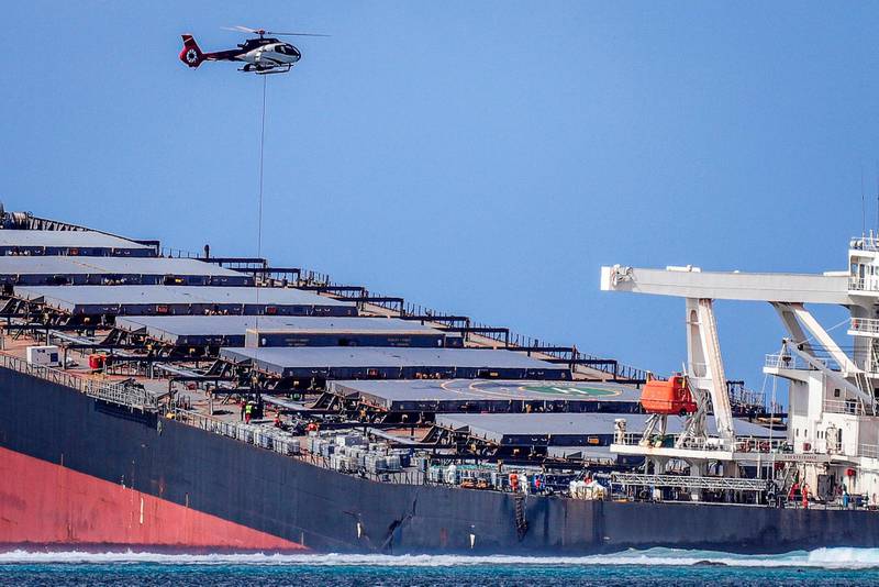 A helicopter hovers over the vessel MV Wakashio in southeast Mauritius.  AFP