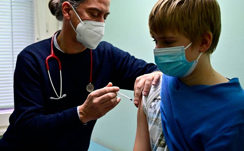 Paediatrician medic Jakob Maske vaccinates an 11-year-old boy in his Berlin office. AFP