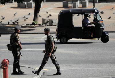 Security officers guard the road to the president’s house in Colombo, after bomb blasts ripped through churches and luxury hotels on Easter, in Sri Lanka. Reuters