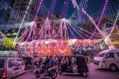 Vehicles, motorcycles, and tuk-tuks (motorised rickshaws) drive past a stall selling Ramadan lanterns along the main street in the northern suburb of Shubra (home to a large Christian population) of Egypt's capital Cairo, at the start of the Muslim holy fasting month of Ramadan. AFP